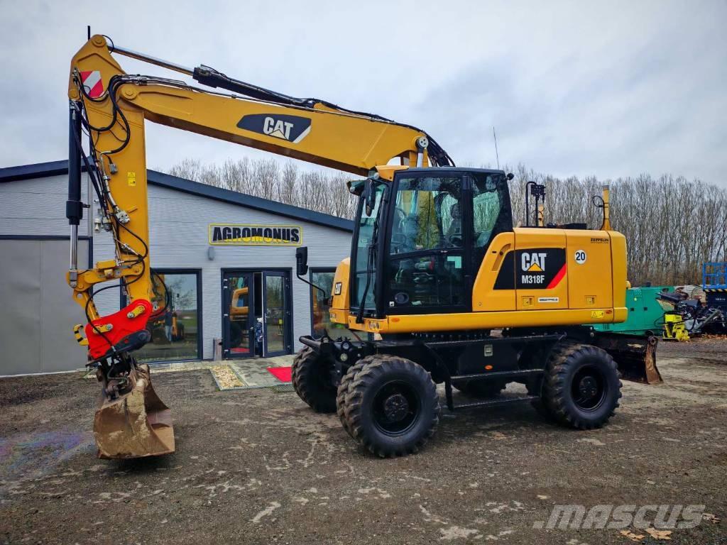 CAT M 318 F Pelle sur pneus