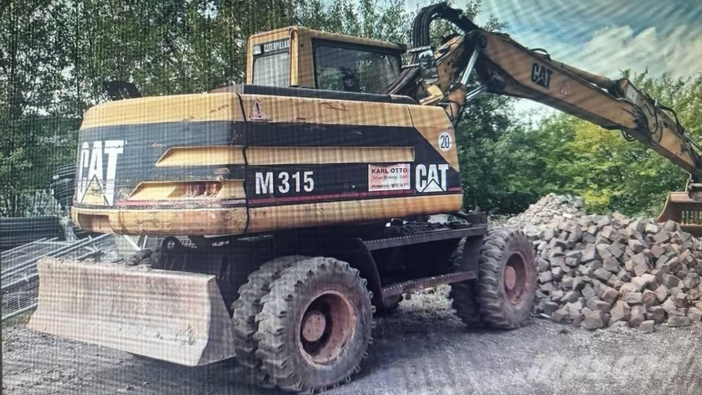 CAT M 315 Pelle sur pneus