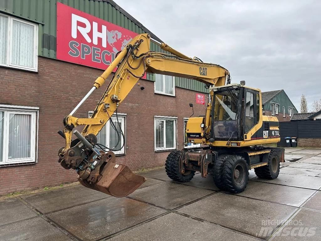 CAT M315 +ROTO CE Pelle sur pneus