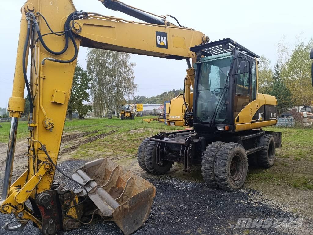 CAT M 318 C Pelle sur pneus
