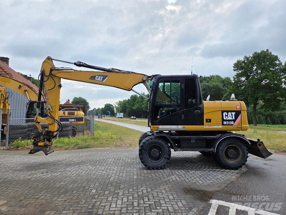 CAT M313D Pelle sur pneus