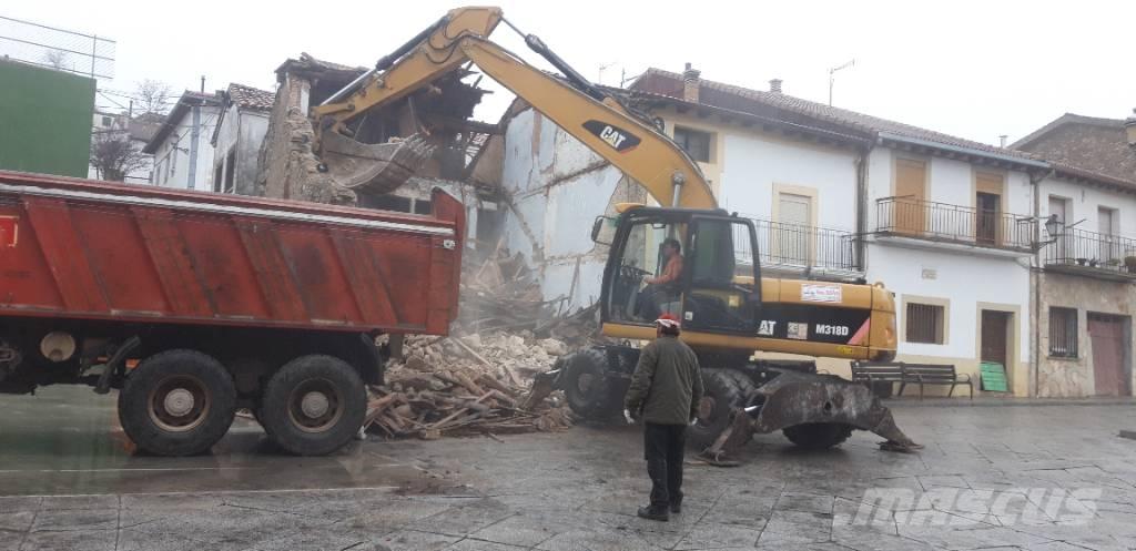 CAT M318d Pelle sur pneus