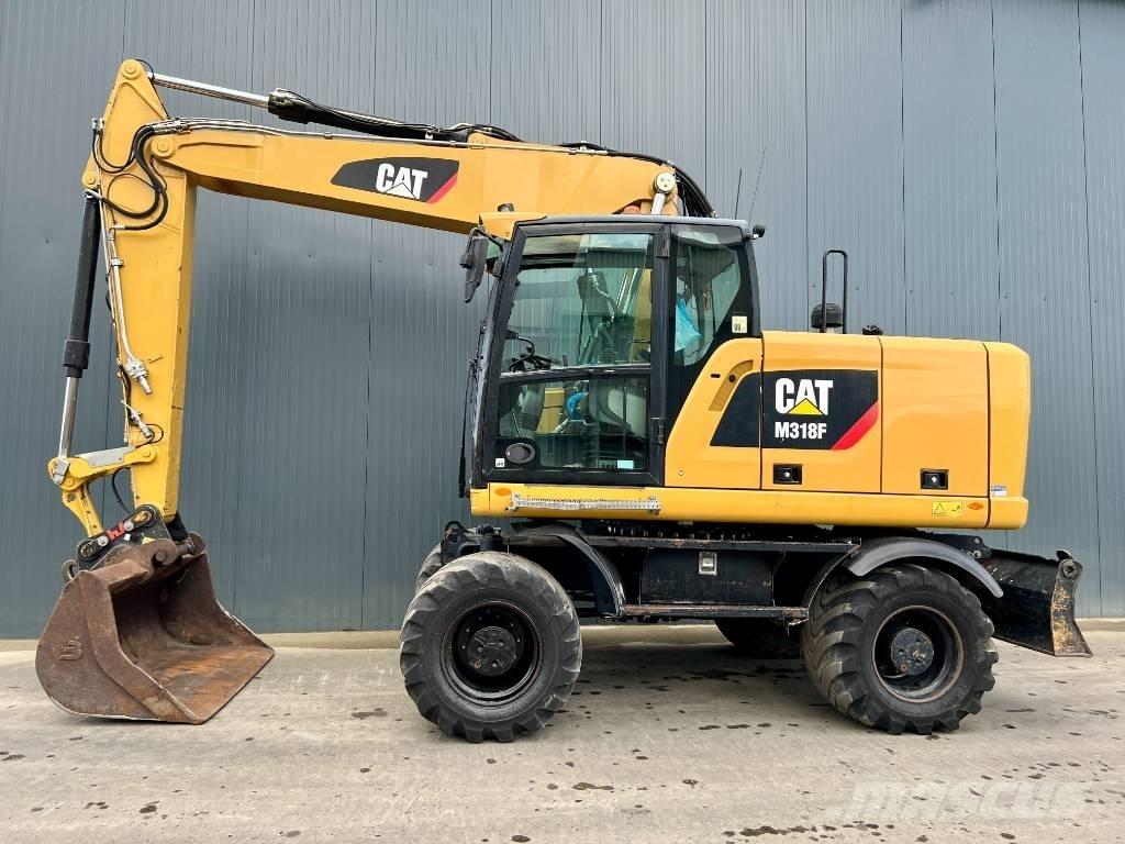 CAT M318F Pelle sur pneus