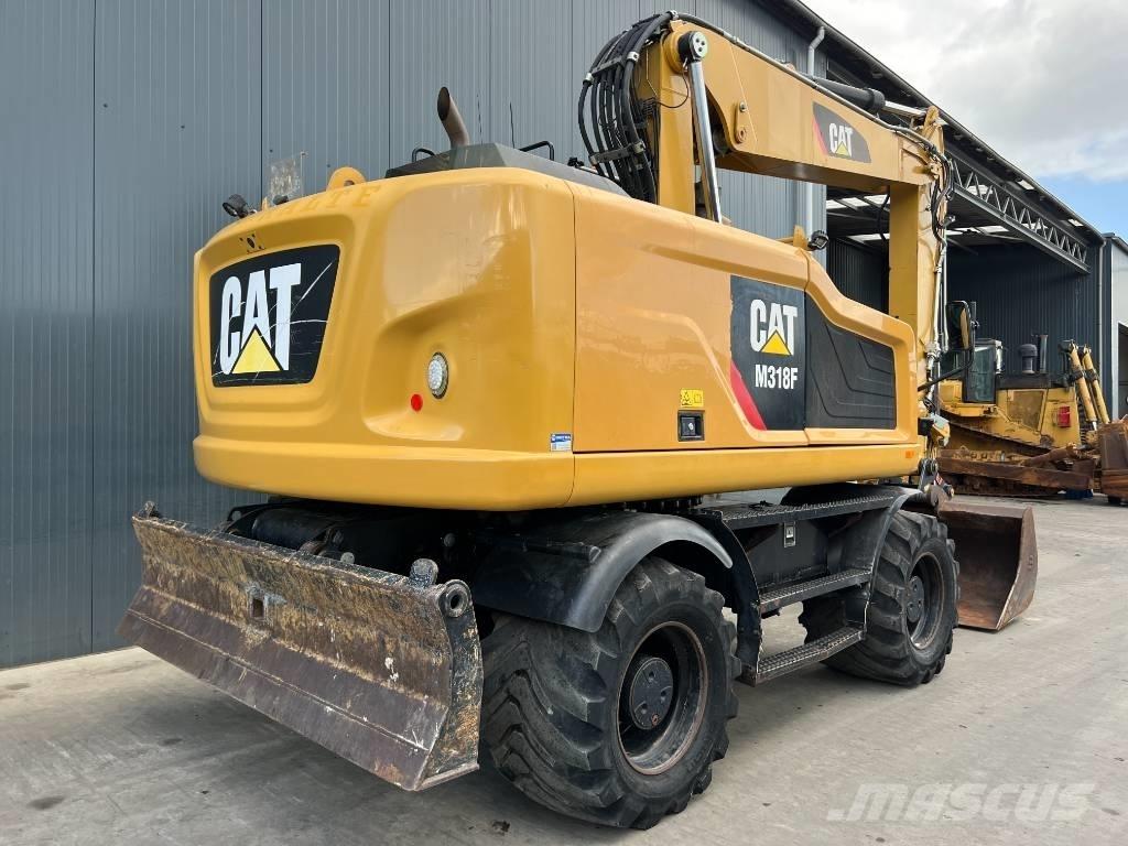 CAT M318F Pelle sur pneus