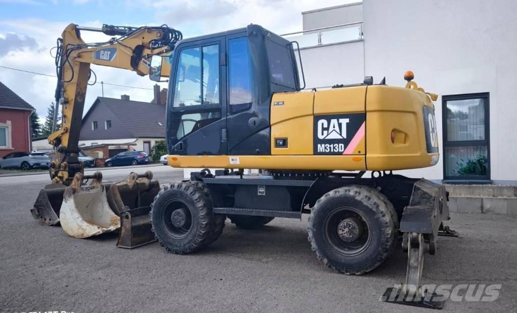 CAT M 313 D Pelle sur pneus