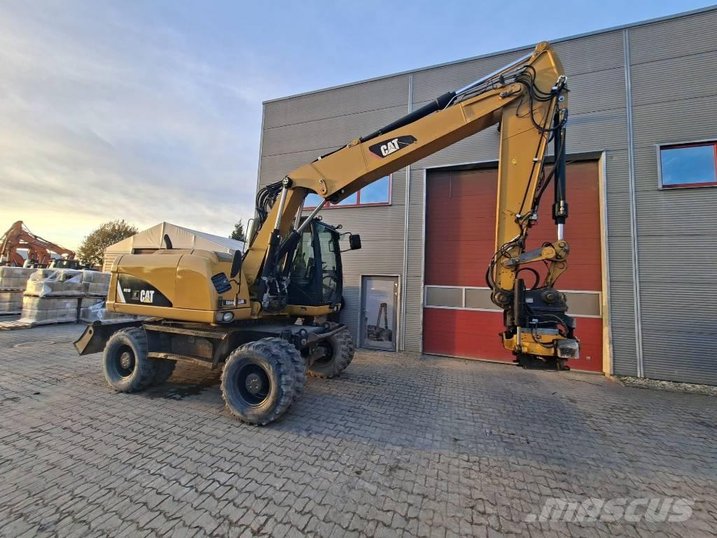 CAT M 313 D Pelle sur pneus