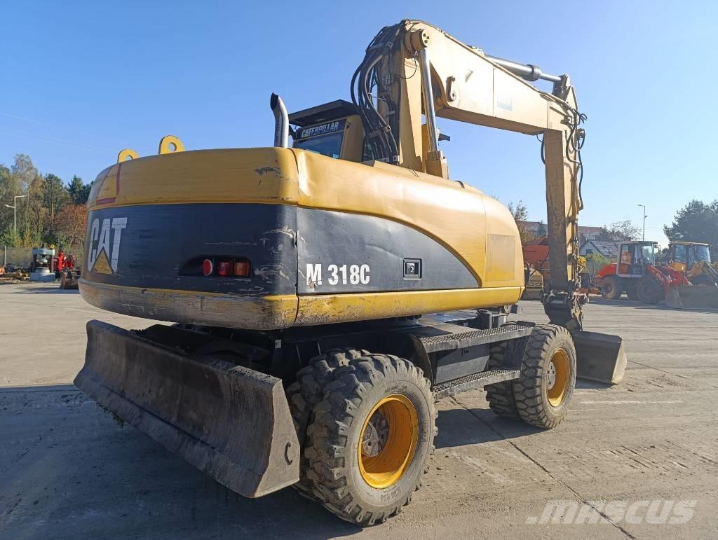 CAT M 318 C Pelle sur pneus