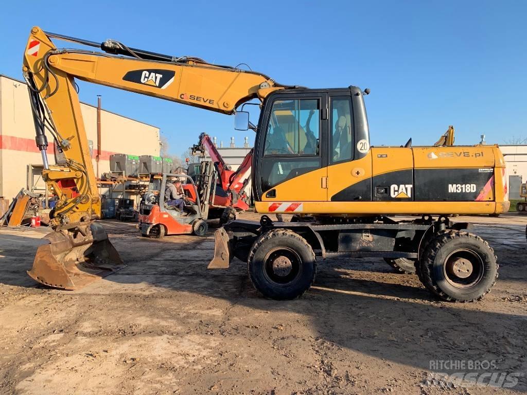CAT M 318 D Pelle sur pneus