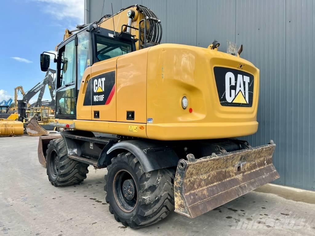 CAT M318F Pelle sur pneus