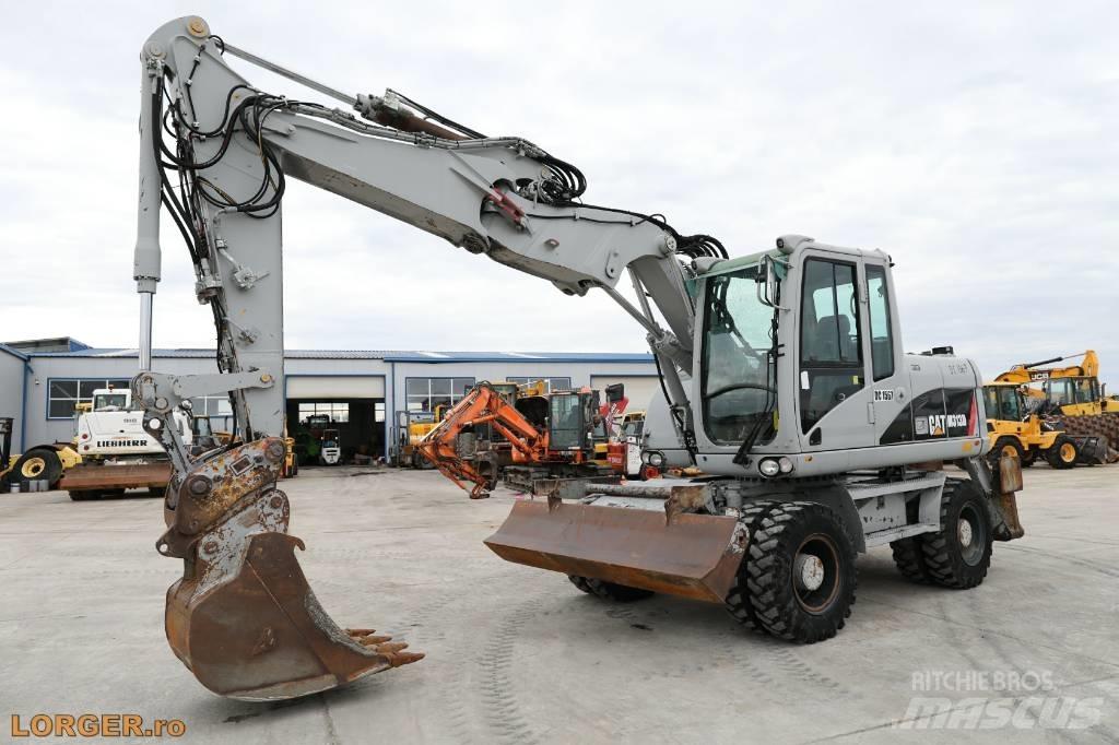 CAT M 313 D Pelle sur pneus