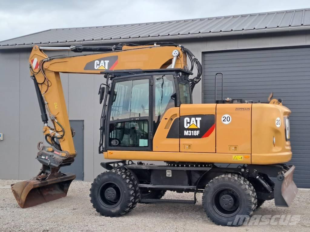 CAT M318F Pelle sur pneus
