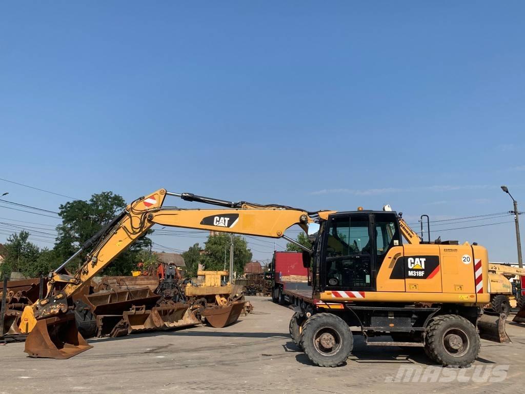 CAT M 318 F Pelle sur pneus