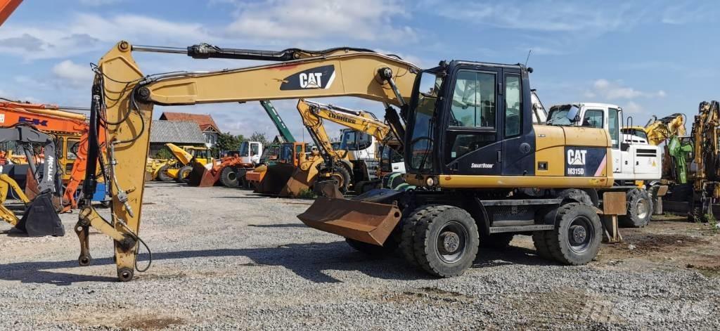 CAT M 315 D Pelle sur pneus