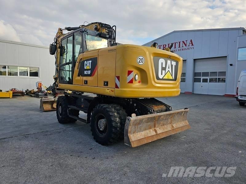CAT M 318 F Pelle sur pneus