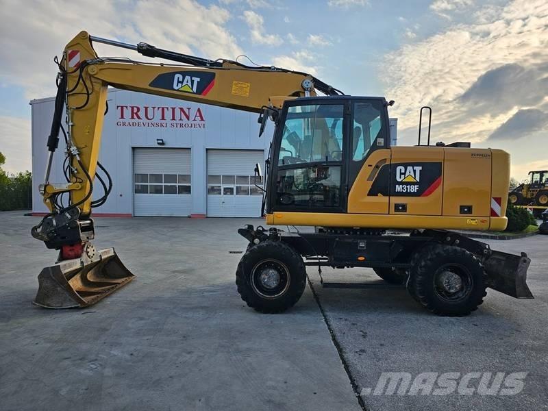 CAT M 318 F Pelle sur pneus