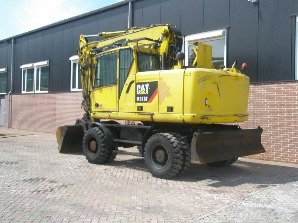 CAT M318F Pelle sur pneus