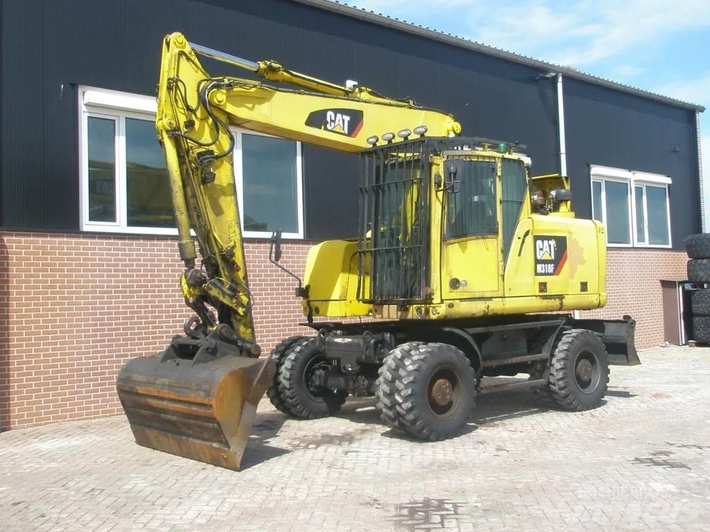 CAT M318F Pelle sur pneus