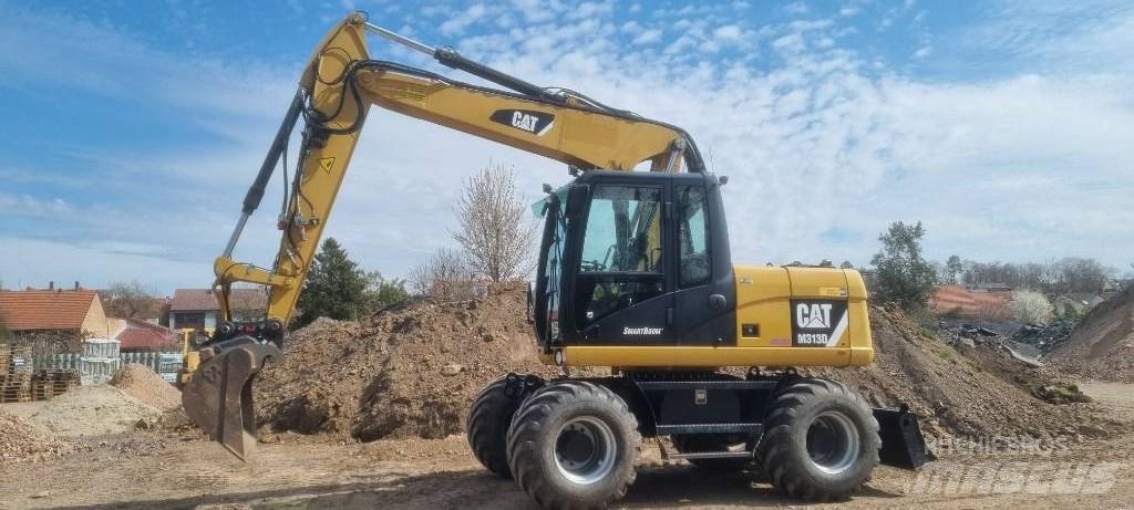 CAT M 313 D Pelle sur pneus