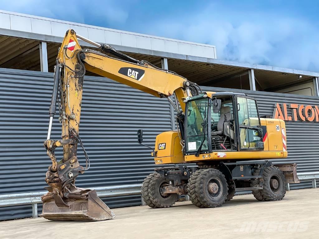 CAT M318F Pelle sur pneus