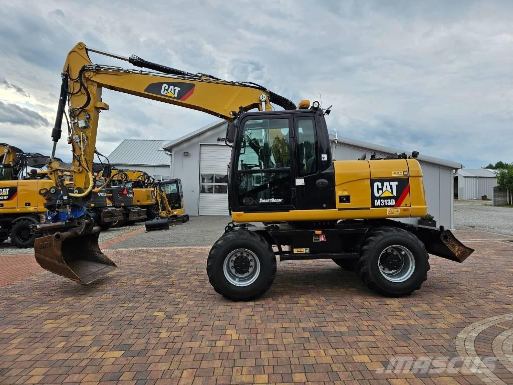 CAT M 313 D Pelle sur pneus