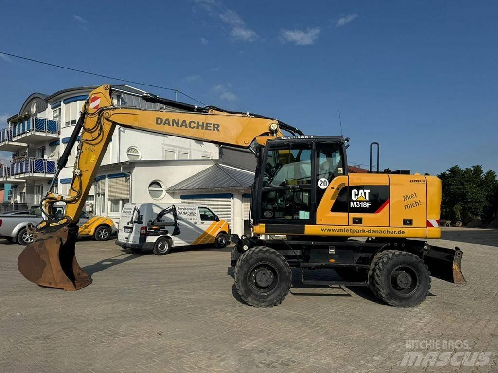 CAT M 318 F Pelle sur pneus