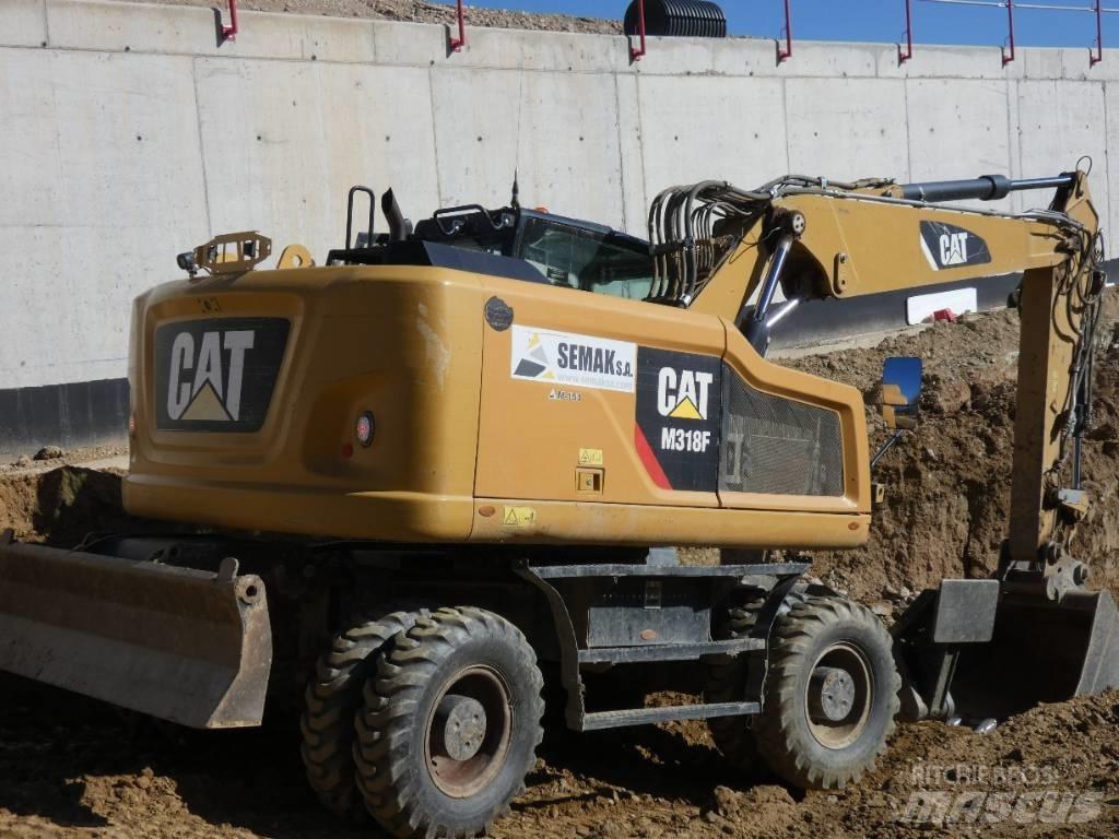 CAT M 318 F Pelle sur pneus
