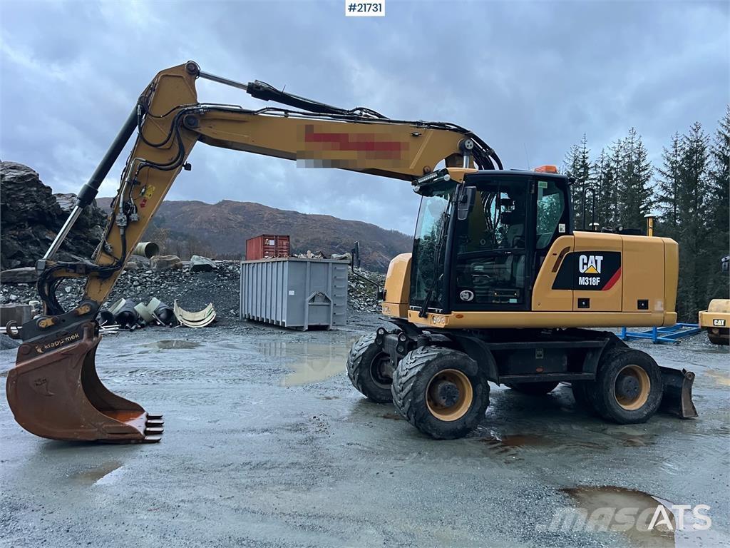 CAT M318F Pelle sur pneus