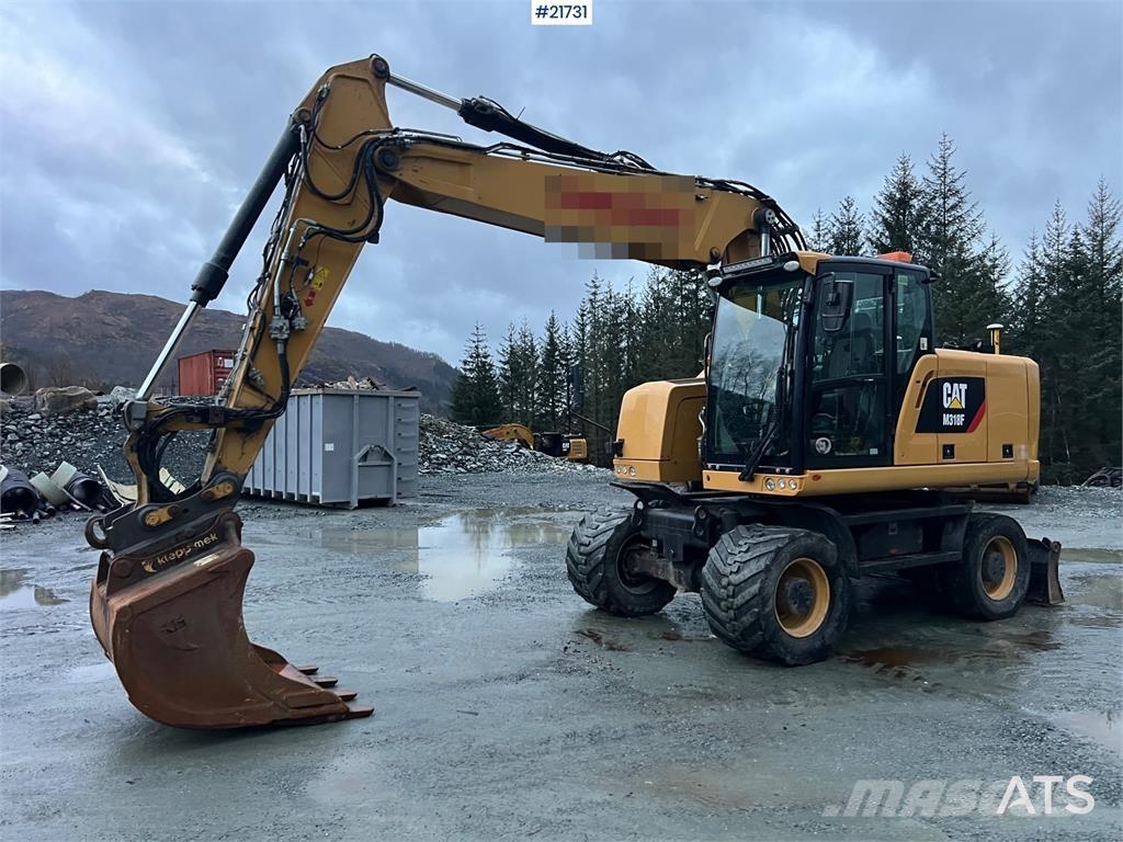 CAT M318F Pelle sur pneus