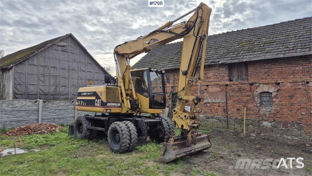 CAT M312 Pelle sur pneus