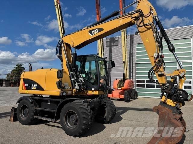 CAT M 313 D Pelle sur pneus