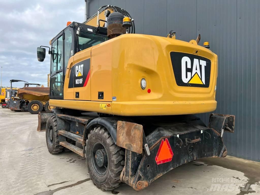 CAT M318F Pelle sur pneus