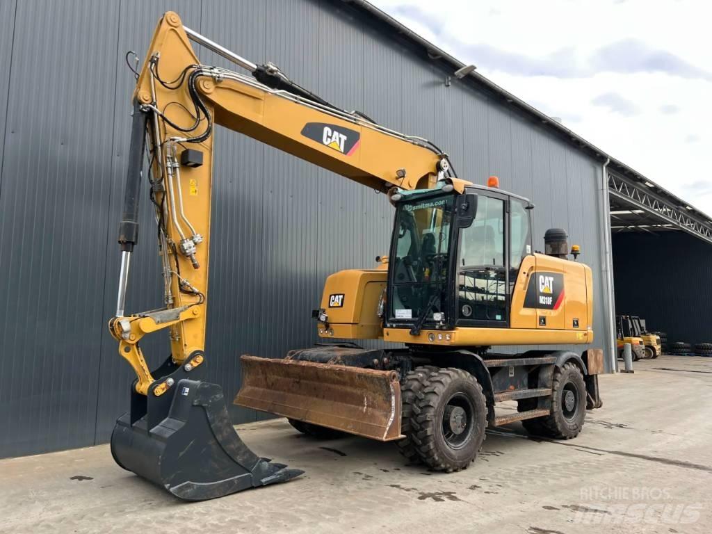 CAT M318F Pelle sur pneus
