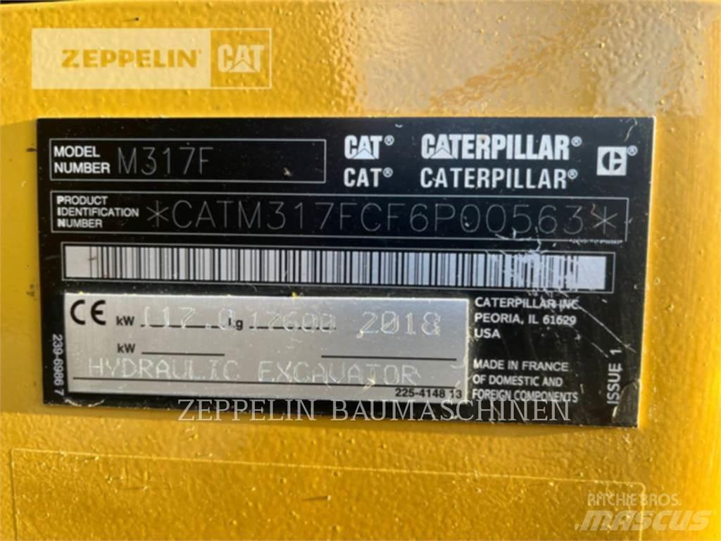 CAT M317F Pelle sur pneus