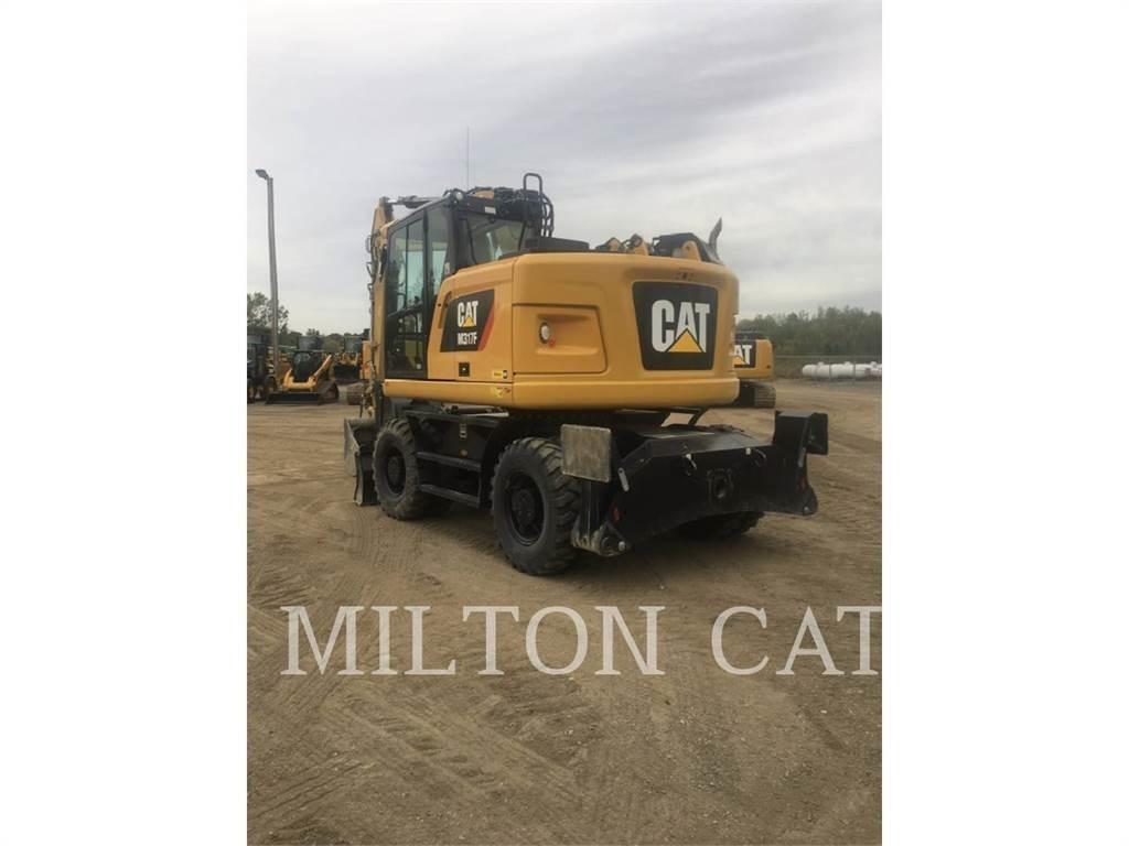 CAT M317F Pelle sur pneus