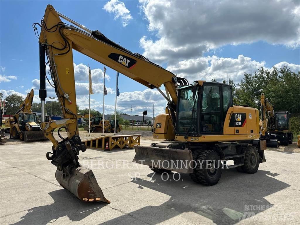 CAT M318F Pelle sur pneus