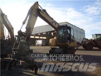 CAT M318F Pelle sur pneus