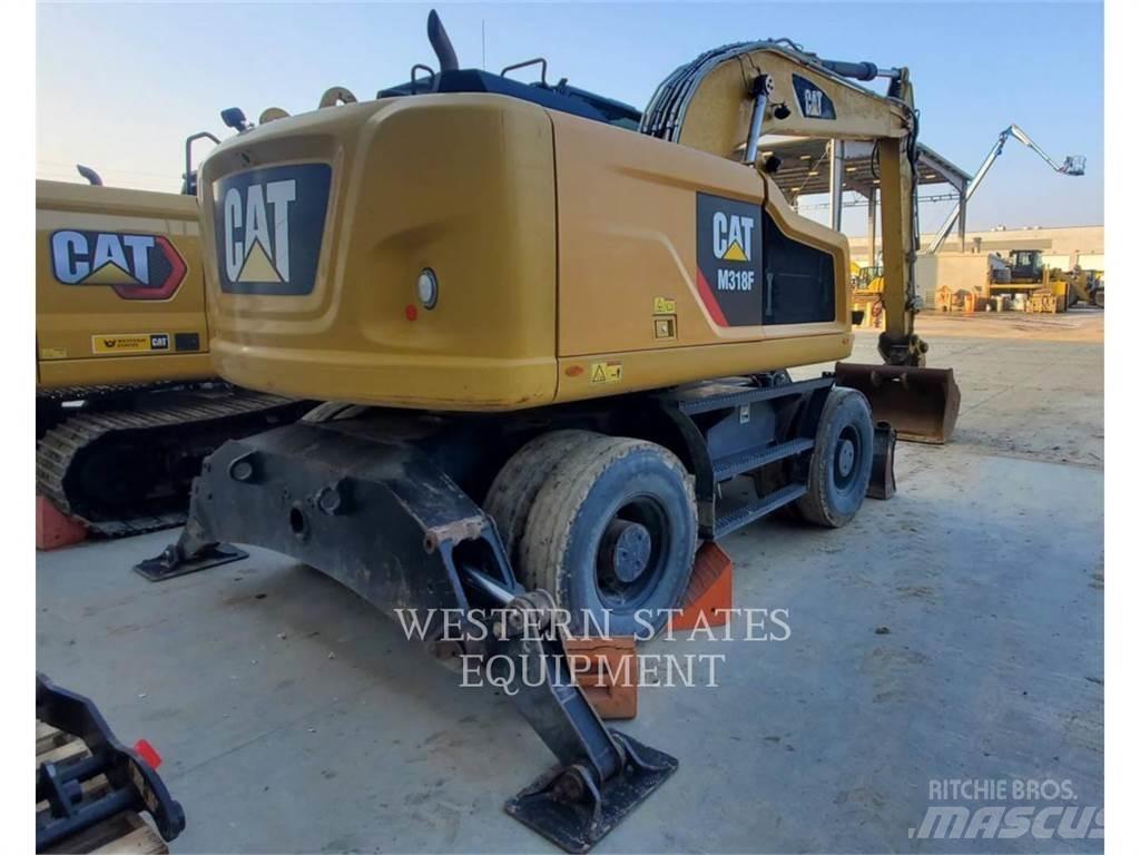CAT M318F Pelle sur pneus