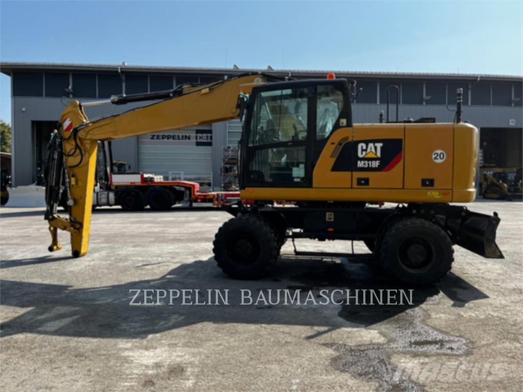 CAT M318F Pelle sur pneus