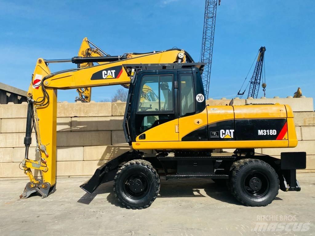 CAT M 318 D Pelle sur pneus