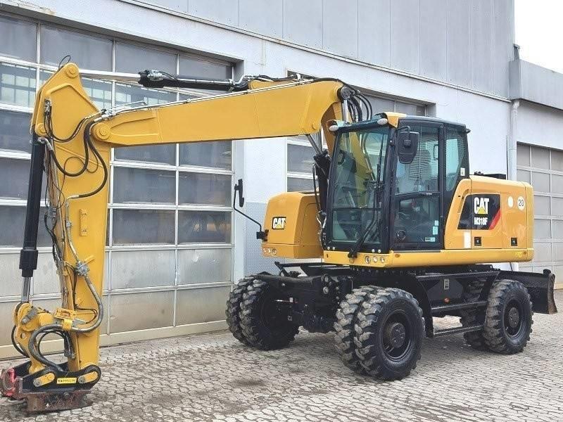 CAT M 318 F Pelle sur pneus