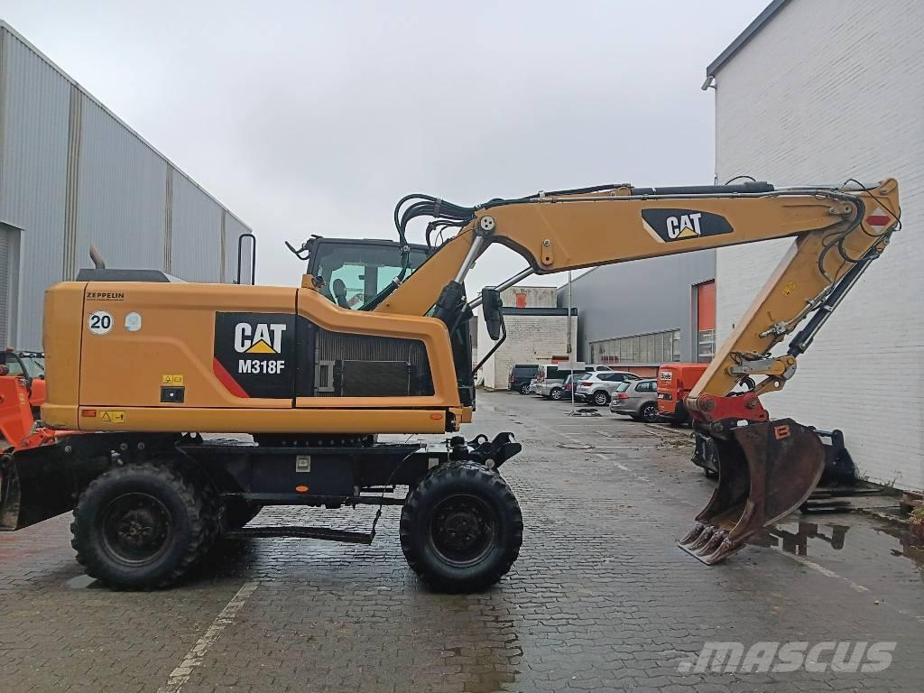 CAT M 318 F Pelle sur pneus