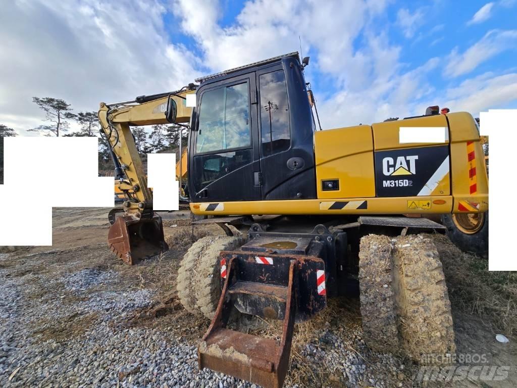 CAT M 315 D Pelle sur pneus