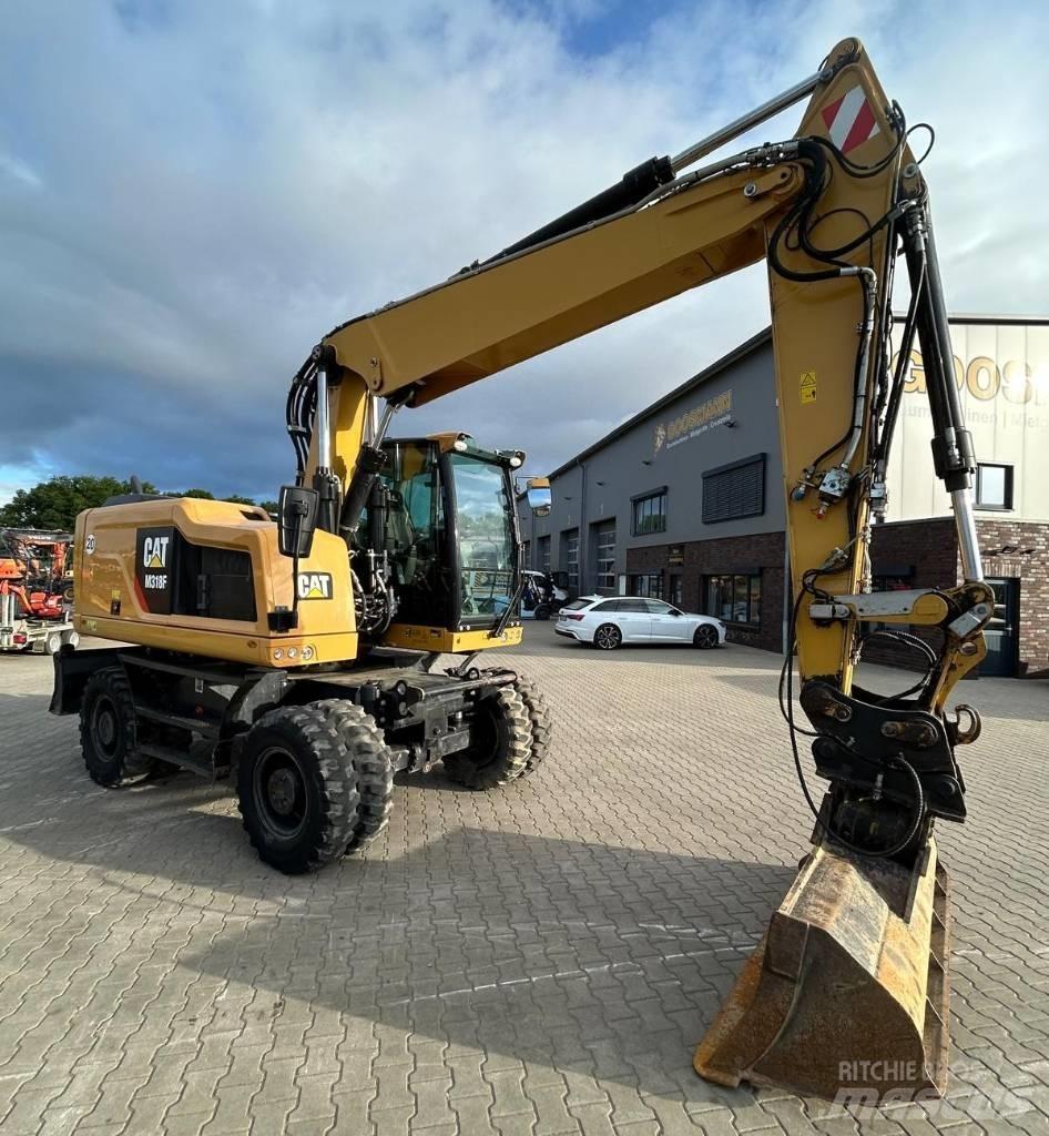 CAT M 318 F Pelle sur pneus