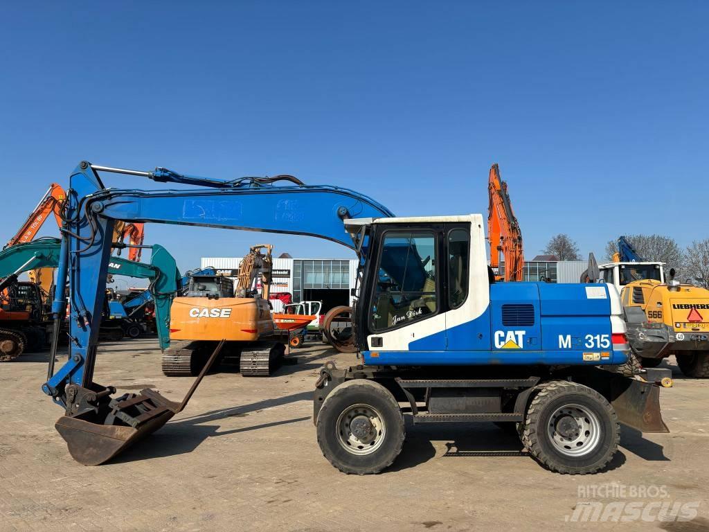 CAT M 315 Pelle sur pneus