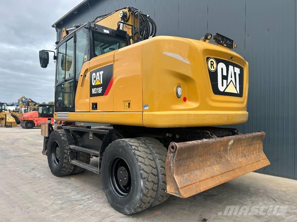 CAT M318F Pelle sur pneus