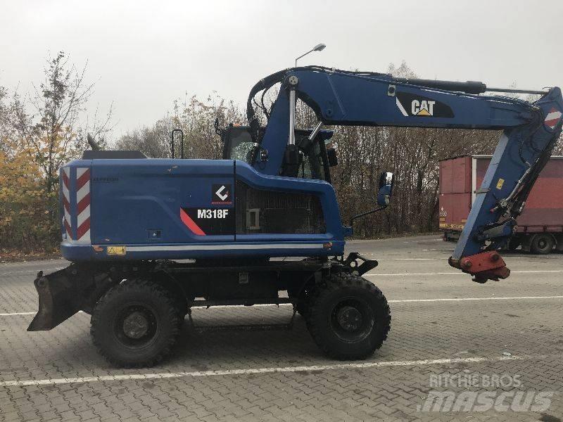 CAT M318F Pelle sur pneus