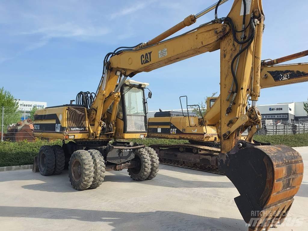 CAT M 318 Pelle sur pneus