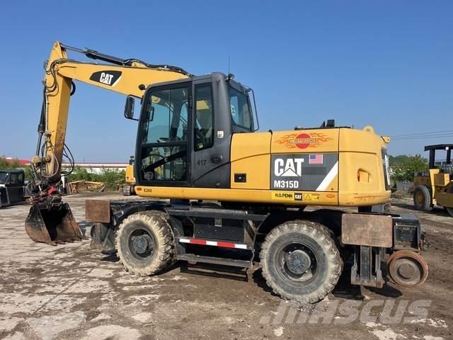CAT M315D Pelle sur pneus