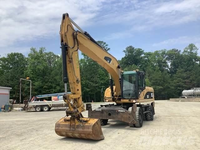 CAT M322D Pelle sur pneus