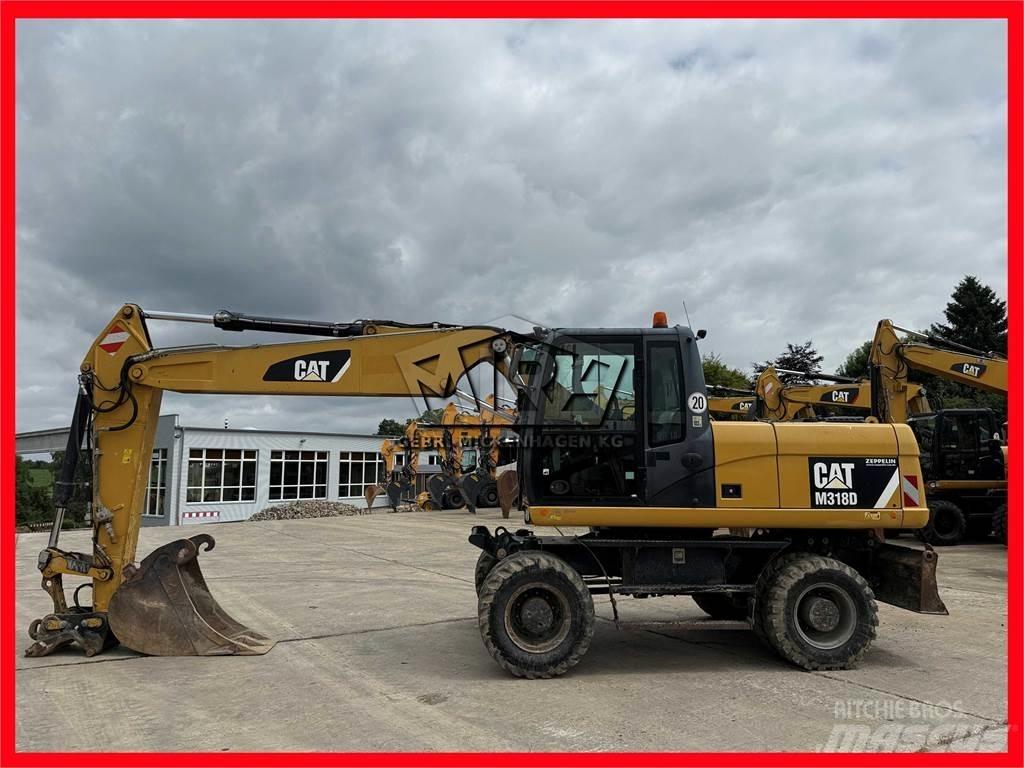 CAT M 318 D Pelle sur pneus